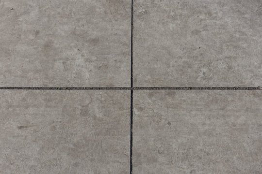 Crossed Joints Between Light Grey Concrete Slabs