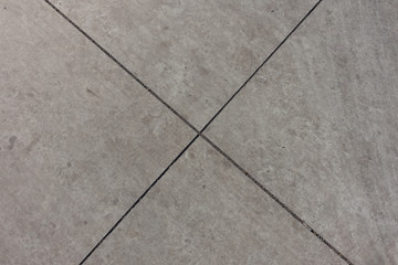 X-shaped joints between light grey concrete slabs