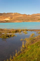Fototapeta premium Turquoise geothermal sulfur lake, lagoon in the desert mountains
