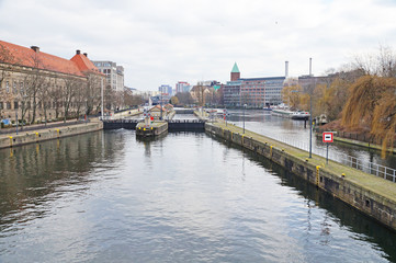 A ship is sailing along a river in the center of Berlin. City landscape. City river transport.