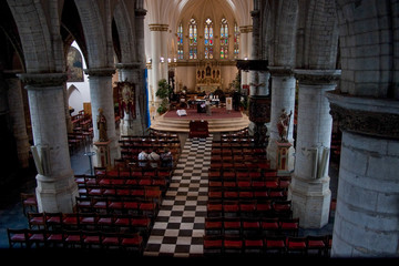 Large European Belgian Church Interior with chairs and altar and tabernacle 