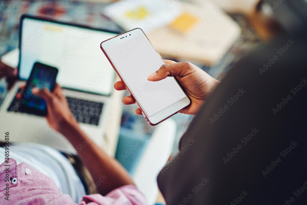 Poster cropped image of woman holding modern mobile phone with mock up screen for share multimedia files,fe
