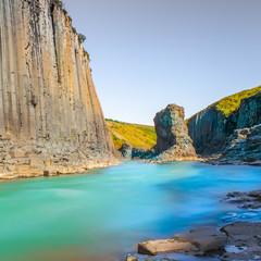 Basalt column canyon with clean glacial river with turquoise and cyan water, Iceland Studlagil Canyon
