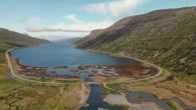 Aerial view over a beautiful Fjord surrounded by large mountains in the Westfjords region of Iceland