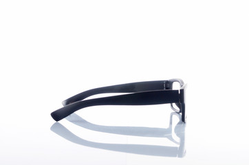 View of black frame spectacles glasses in a white background. Selective focus. 
