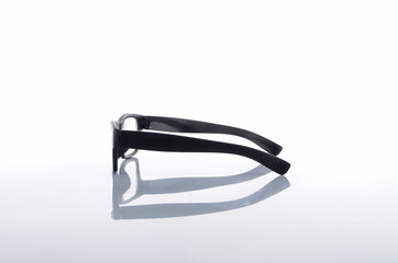 View of black frame spectacles glasses in a white background. Selective focus. 