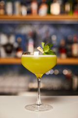 glass with mixed alcohol cocktail on bar counter