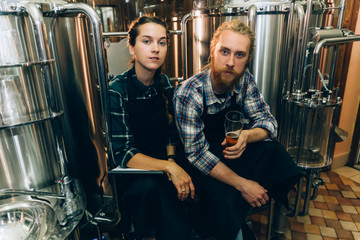 Portrait of Brewery workers. Male and female brewer at brewery factory. 4k. Small business concept.