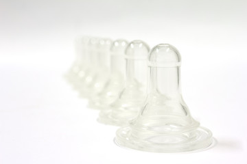 Babies silicone teats on white background, feed concept, isolated.