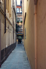 A narrow street through the Venetian houses