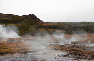 Rusty landscape and steaming hot springs