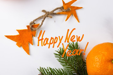 New Year Concept postcard. Christmas decorations hand made from tangerine peel and fir-tree branches and lettering