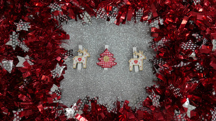 New Year's decoration. Red and silver Twisted Tinsel Garland as a frame. Silver glitter background.