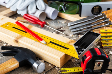 View from above of carpenter's tools on an antique wooden table. Construction industry, do it yourself. Wooden work table.