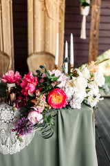 composition with bright pink peony and green branches