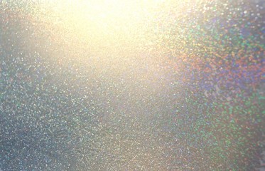 Glitter silver shimmer texture. Brilliance cristals iridescent pattern. Diamond sparkles on grey background. Spectrum light.