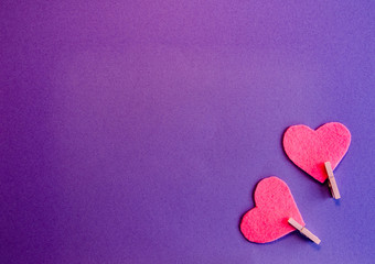 Pink felt hearts on a purple background. Flat lay. Happy Valentine.