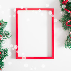 Christmas modern composition. Red photo frame, Xmas decorations on white background. Christmas, New Year, winter concept. Flat lay, top view, copy space