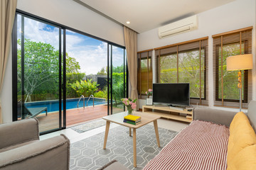 living room with pool view in luxury home