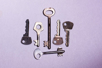 several iron keys lie on a white background