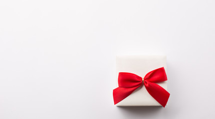 Present white gift box with red bow