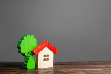 Wooden house and trees. Affordable comfortable housing. Purchase of apartments and real estate,...