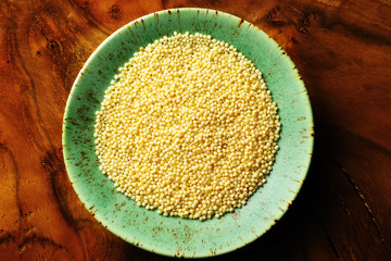 Millet dry seeds in bowl, top view 