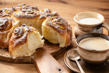 Homemade lemon sweet swirl buns, on wooden background.