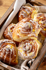 Homemade lemon sweet swirl buns, on wooden background.