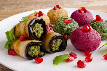 fried eggplant slices and boiled grated vegetables cooked with processed walnuts garlic, herbs, and...