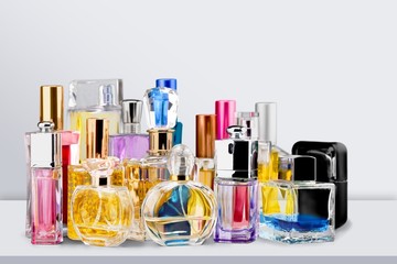 Aromatic Perfume bottles on the wooden desk at wooden background - obrazy, fototapety, plakaty