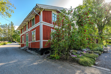 A traditional white and red painted wooden house building in Skansen open-air museum, Stockholm, Sweden.
