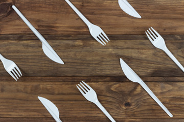 set of plastic cutlery on a wooden background	