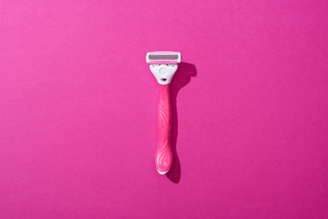 top view of female shaver on pink background