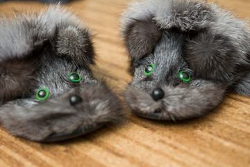 Fluffy fur Slippers in the form of hedgehogs are on the floor of the cork. Selective focus.