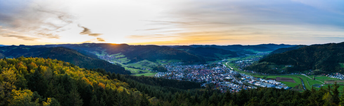 Germany, XXL aerial panorama view above endless magical black forest holiday nature landscape over tree tops at sunset in autumn season at haslach in kinzig valley
