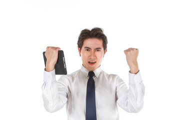 Portrait of smart young asian businessman wearing white shirt holding computer tablet feelings glad and raised two fist on isolated white background and copy space.