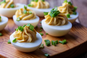 Deviled eggs on rustic wooden background