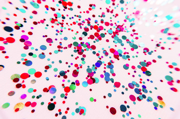 Glitter flying sparkles on pink pastel trendy background. Festive backdrop for graphic design projects.