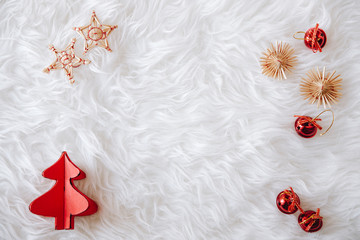 top view of Christmas composition on white snowy background for greeting card. wood tree decoration and little christmas red balls