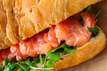 fish sandwich and greens, Smorrebrod (salted salmon, croissant, bread, arugula and other ingredients) menu concept. food background. top view. copy space