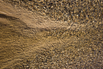 the structure of water in shades of sunlight, the manifestation of texture in the form of abstraction