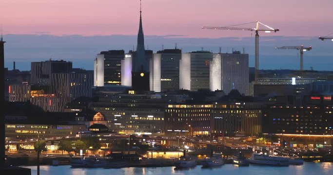 Stockholm, Sweden. Night View Of Stockholm Cityscape Skyline. 4K. Building Of St. Clara Or Saint Klara Church In Summer Sunny Modern Cityscape Skyline