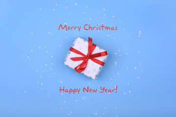 Fototapeta na wymiar Happy New Year and Merry Christmas. Gift on a blue background. Greeting card.