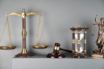 Judge and justice concept. Scale, hourglass and gavel on off-white background.