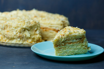 homemade Napoleon cake with cream on a gray background