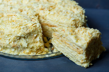 homemade Napoleon cake with cream on a gray background