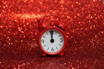 Red evening clock showing noon or midnight on a red background. Negative space. Copy space for advertising. Copy space area for text.