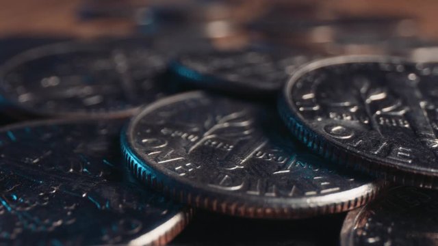 Light shines across a pile of American dime coins