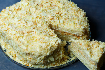 homemade Napoleon cake with cream on a gray background